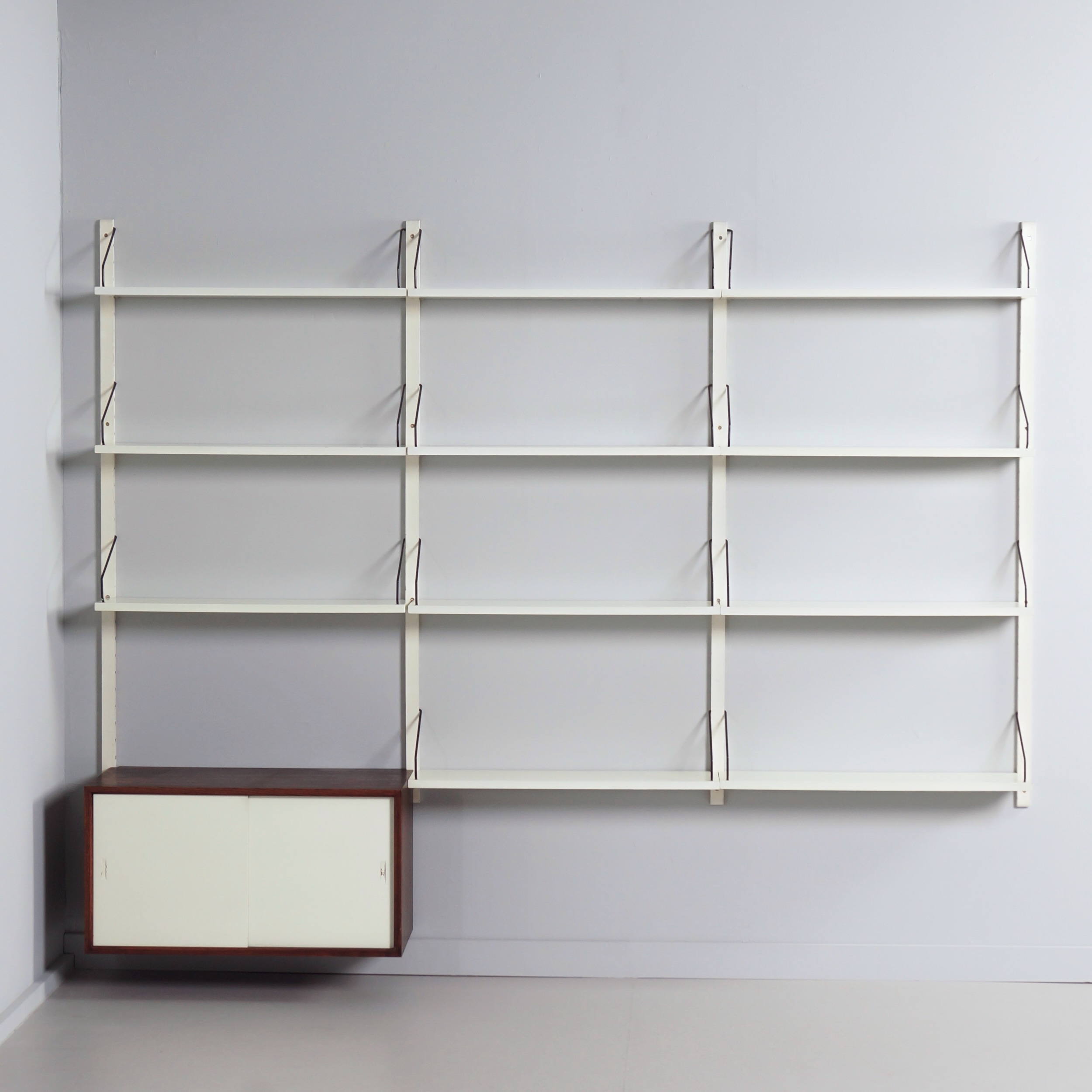 Royal System Wall system by Poul Cadovius for Cado from the 70s in white wood and rosewood