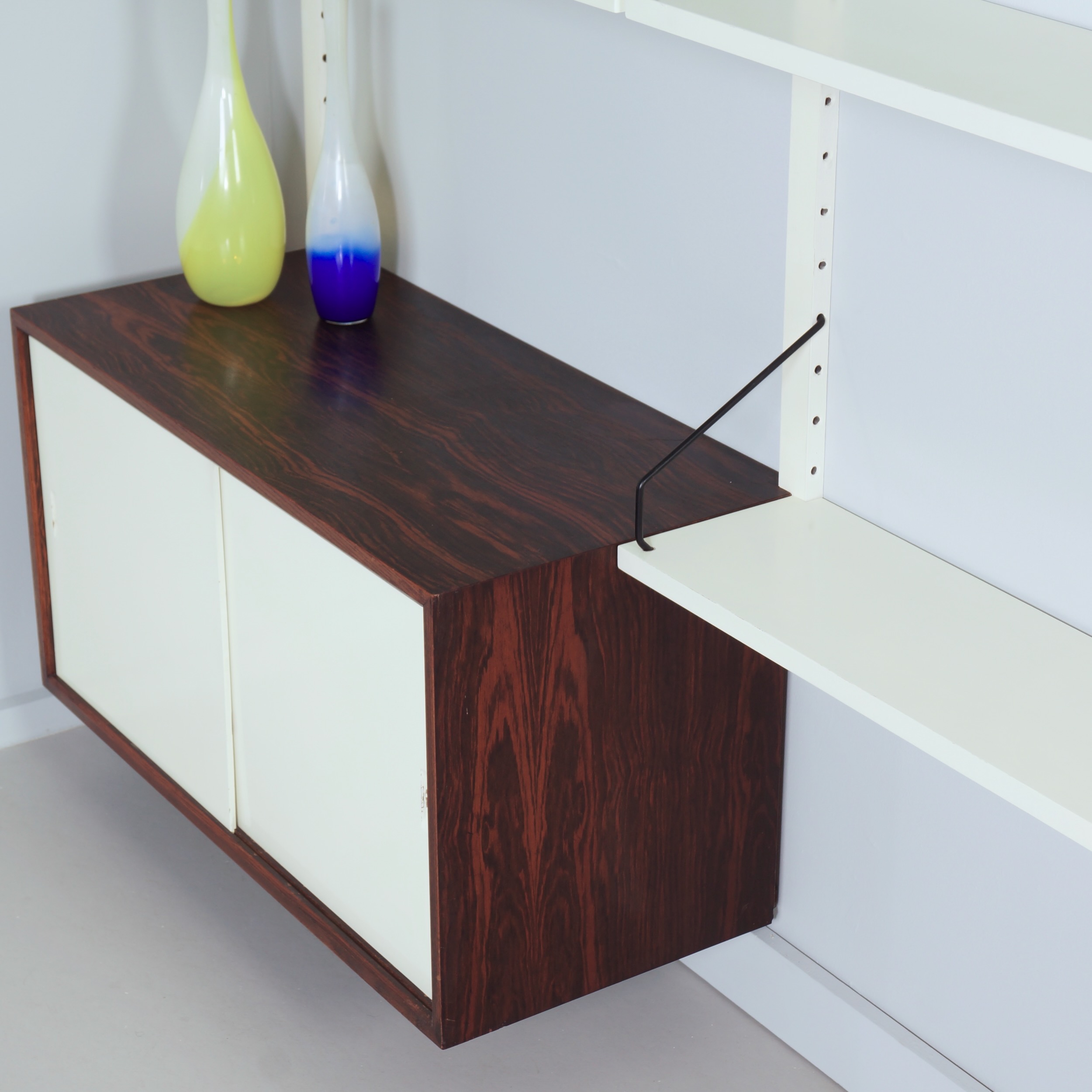 Royal System Wall system by Poul Cadovius for Cado from the 70s in white wood and rosewood